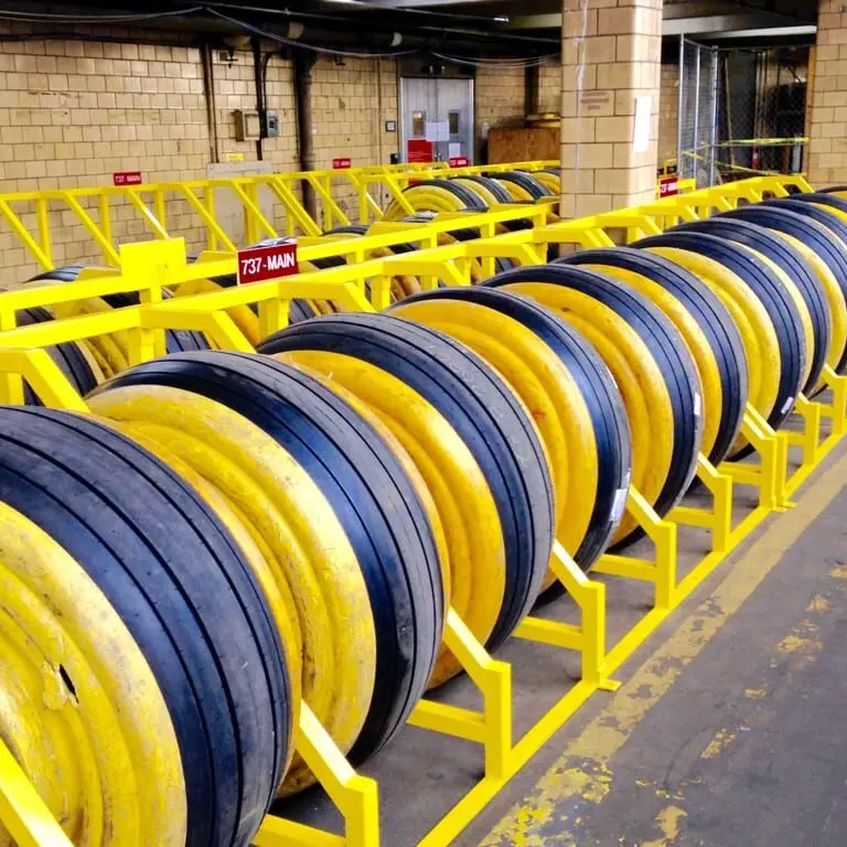 A yellow and black hose rack with many hoses