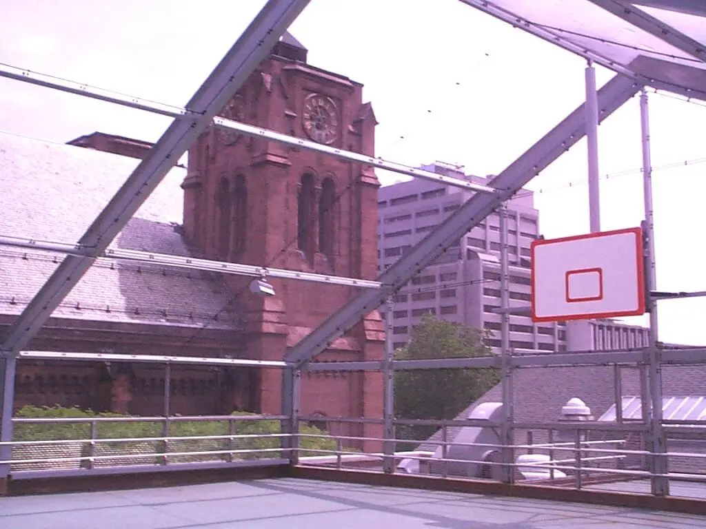 A basketball court with a clock tower in the background.