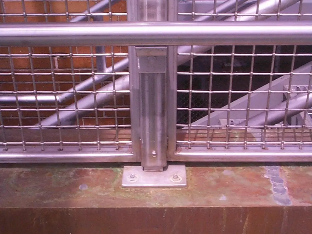 A metal railing with bars on the bottom of it.