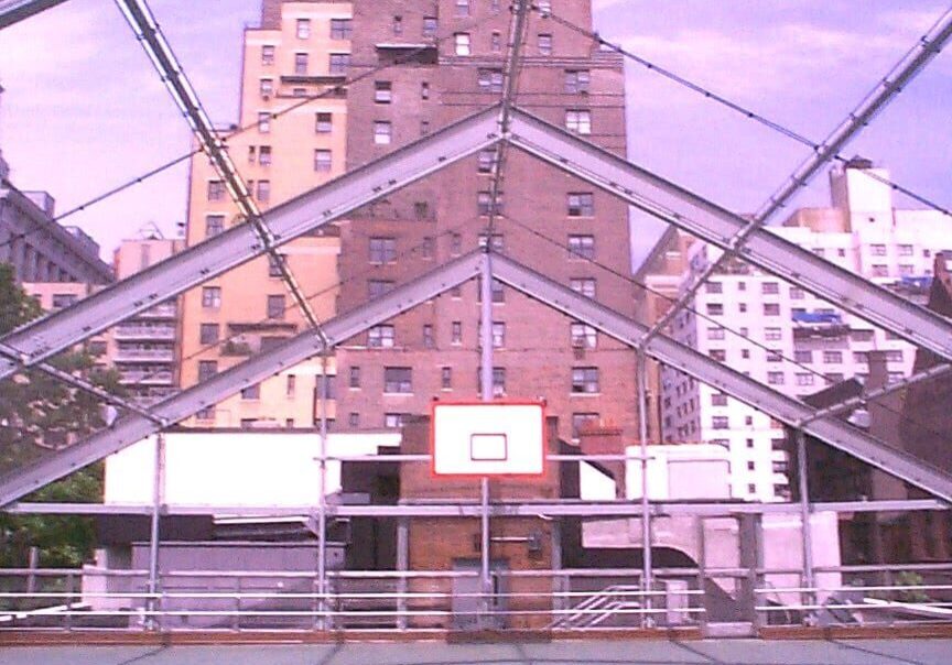 A basketball court with a view of the city.